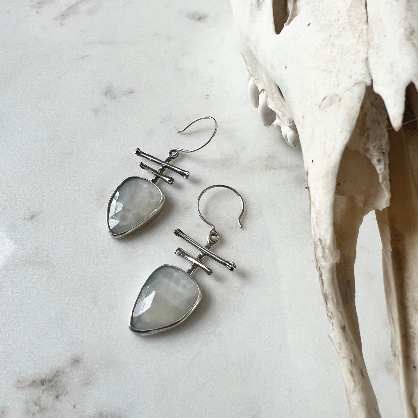 Totem earrings with faceted fancy White Moonstone