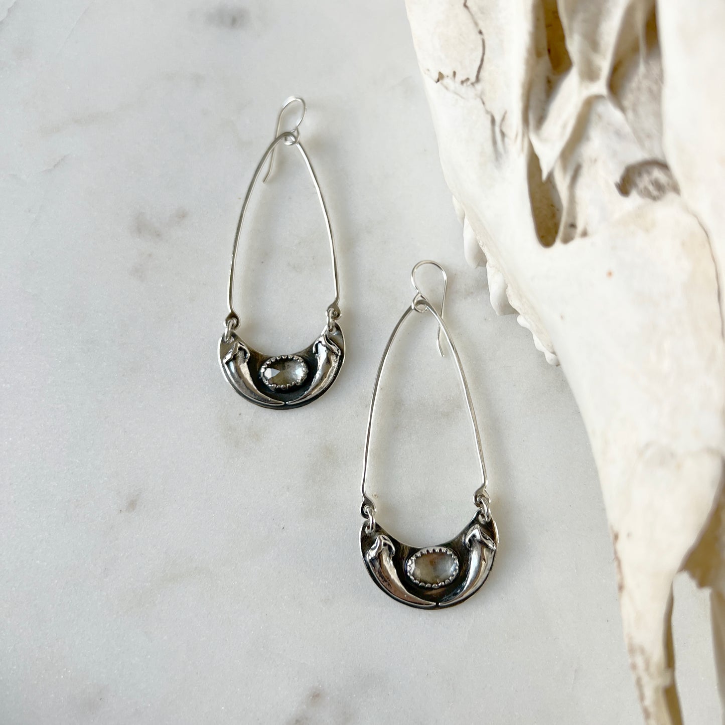 Fox claw crescent earrings with faceted clear topaz