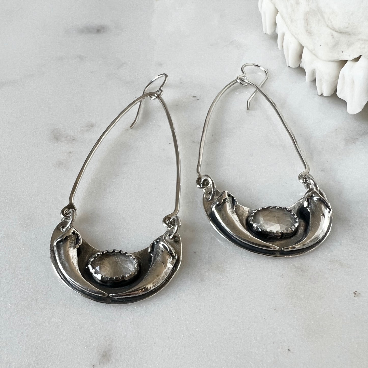 Fox claw crescent earrings with faceted clear topaz