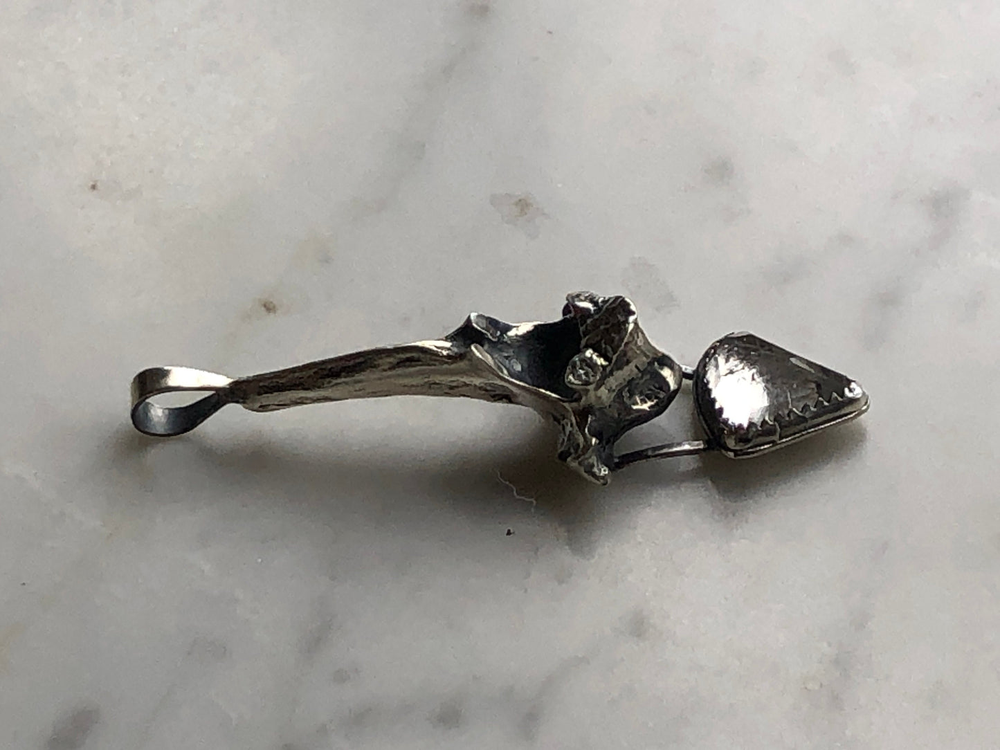 Faceted white topaz with sterling silver fox vertebra pendant