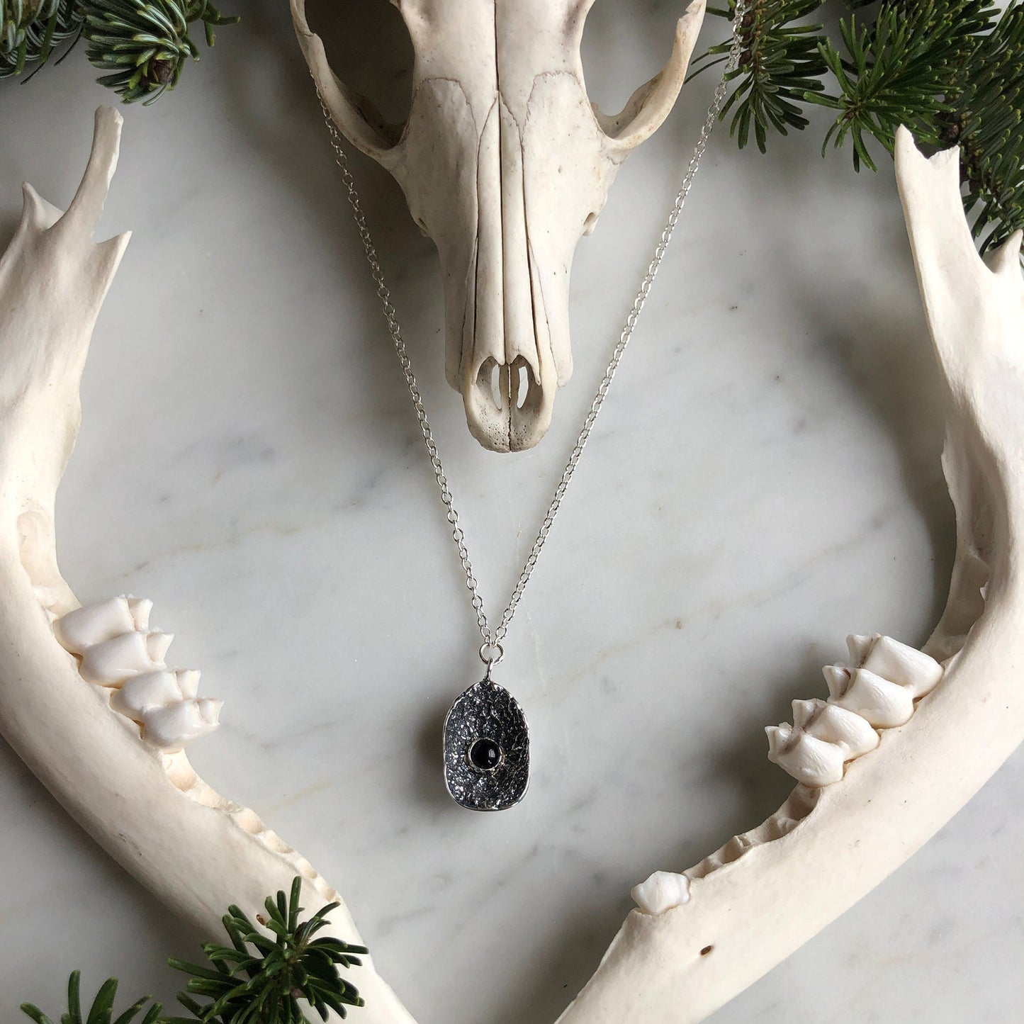 deer vertebral epiphysis necklace (7/8" cupped) with black onyx