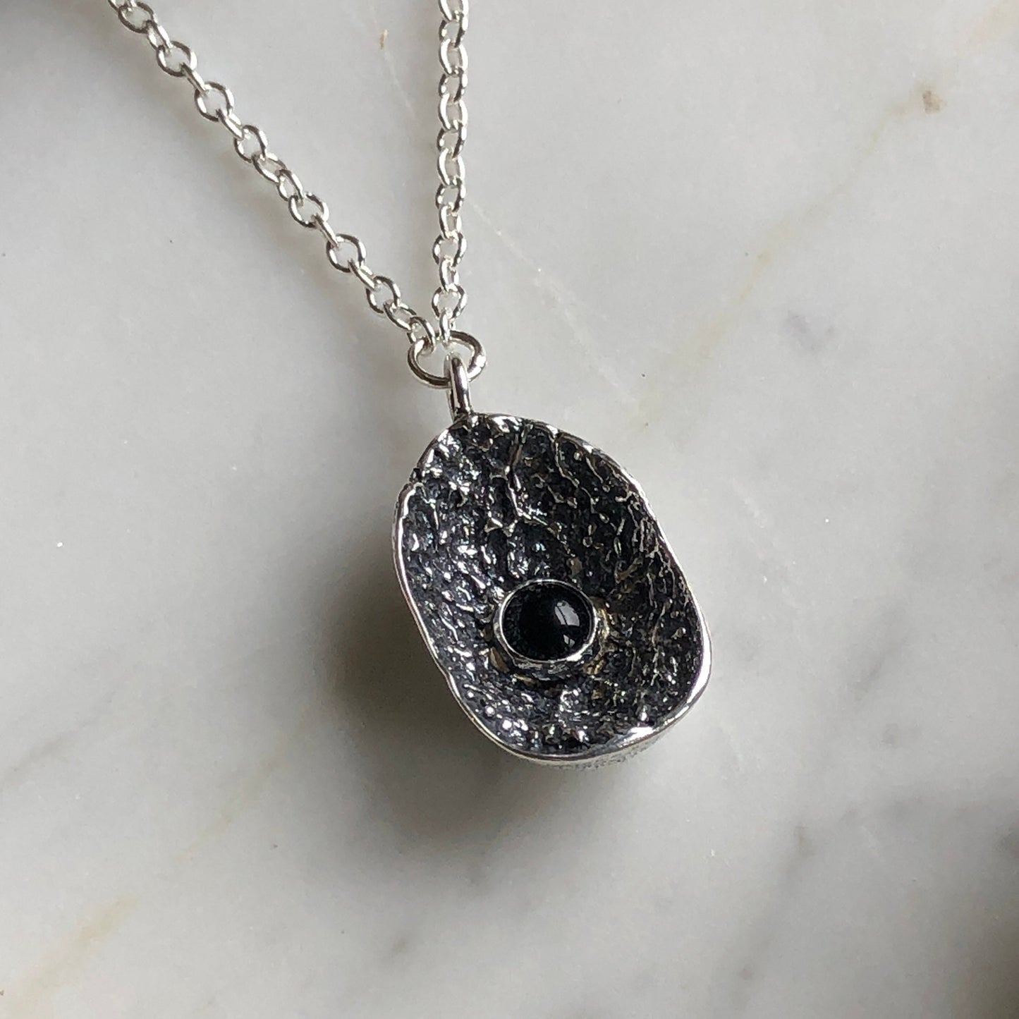deer vertebral epiphysis necklace (7/8" cupped) with black onyx