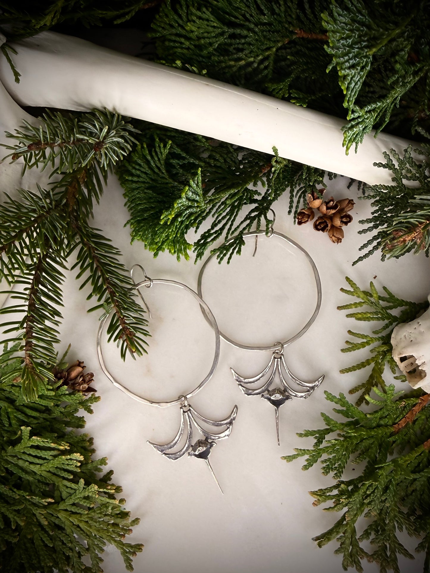 Large hoop earrings with castings of squirrel ribs and vertebrae