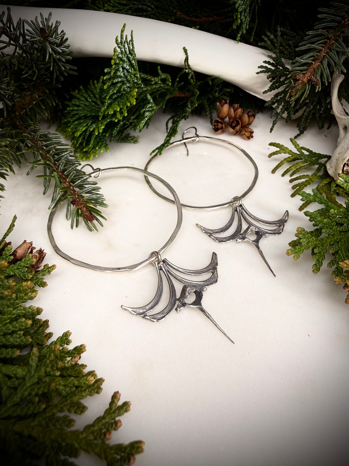 Large hoop earrings with castings of squirrel ribs and vertebrae