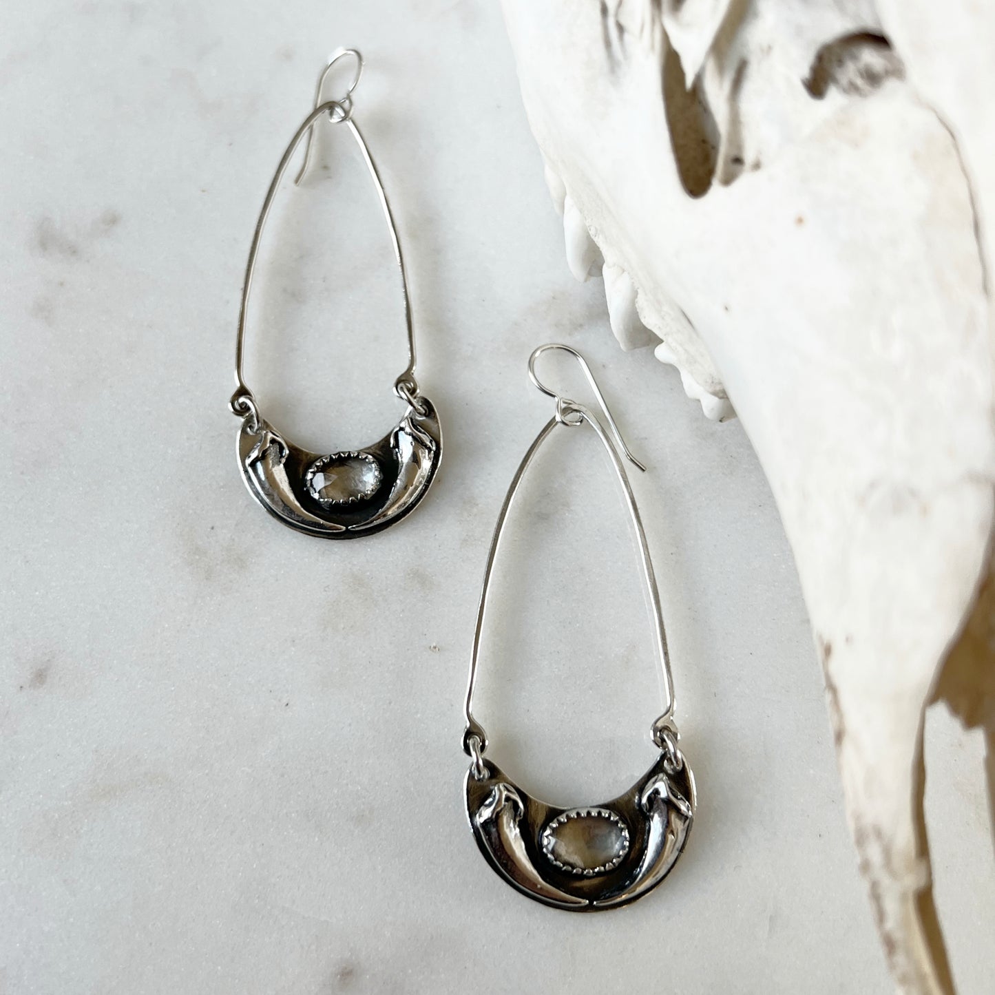 Fox claw crescent earrings with faceted clear topaz