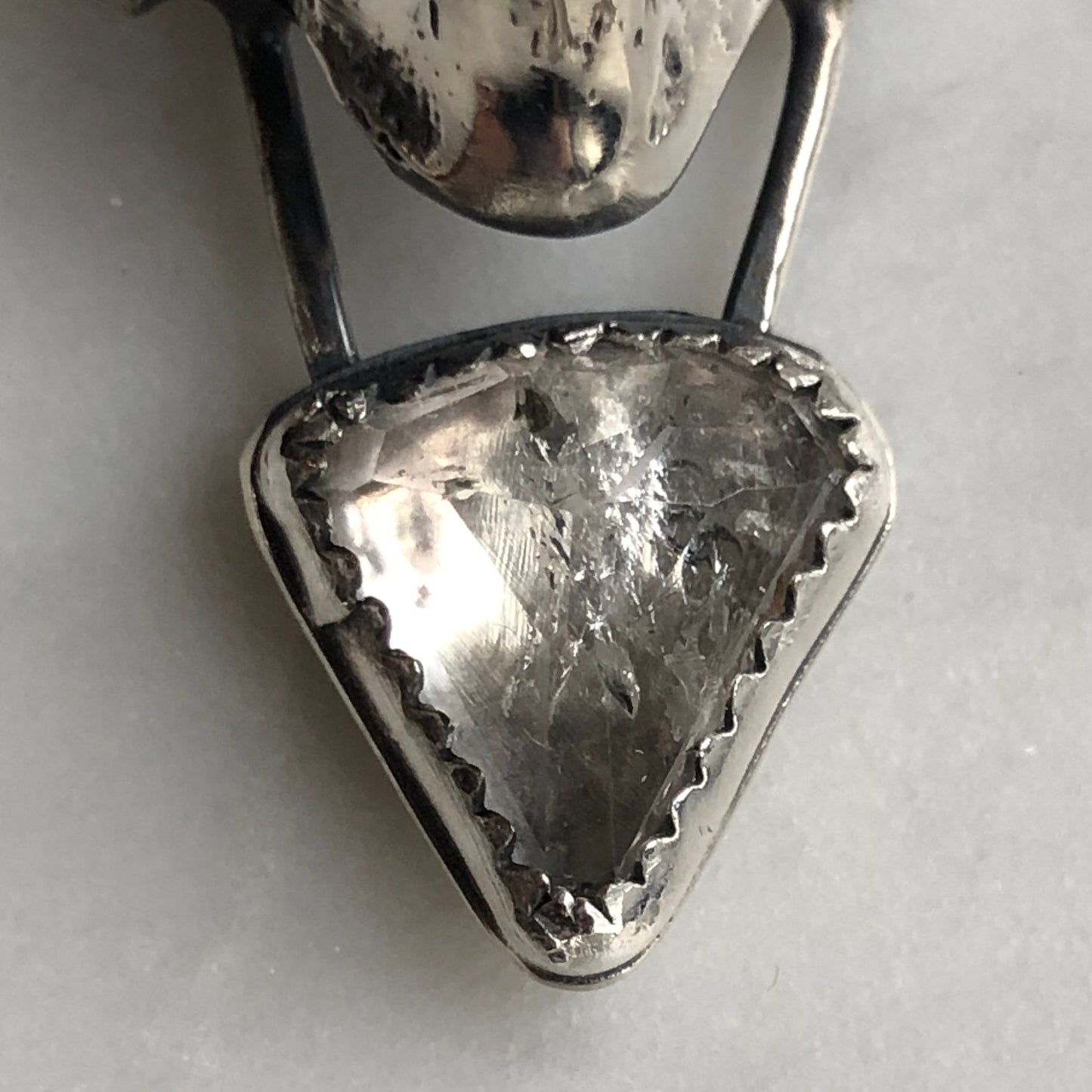 Faceted white topaz with sterling silver fox vertebra pendant