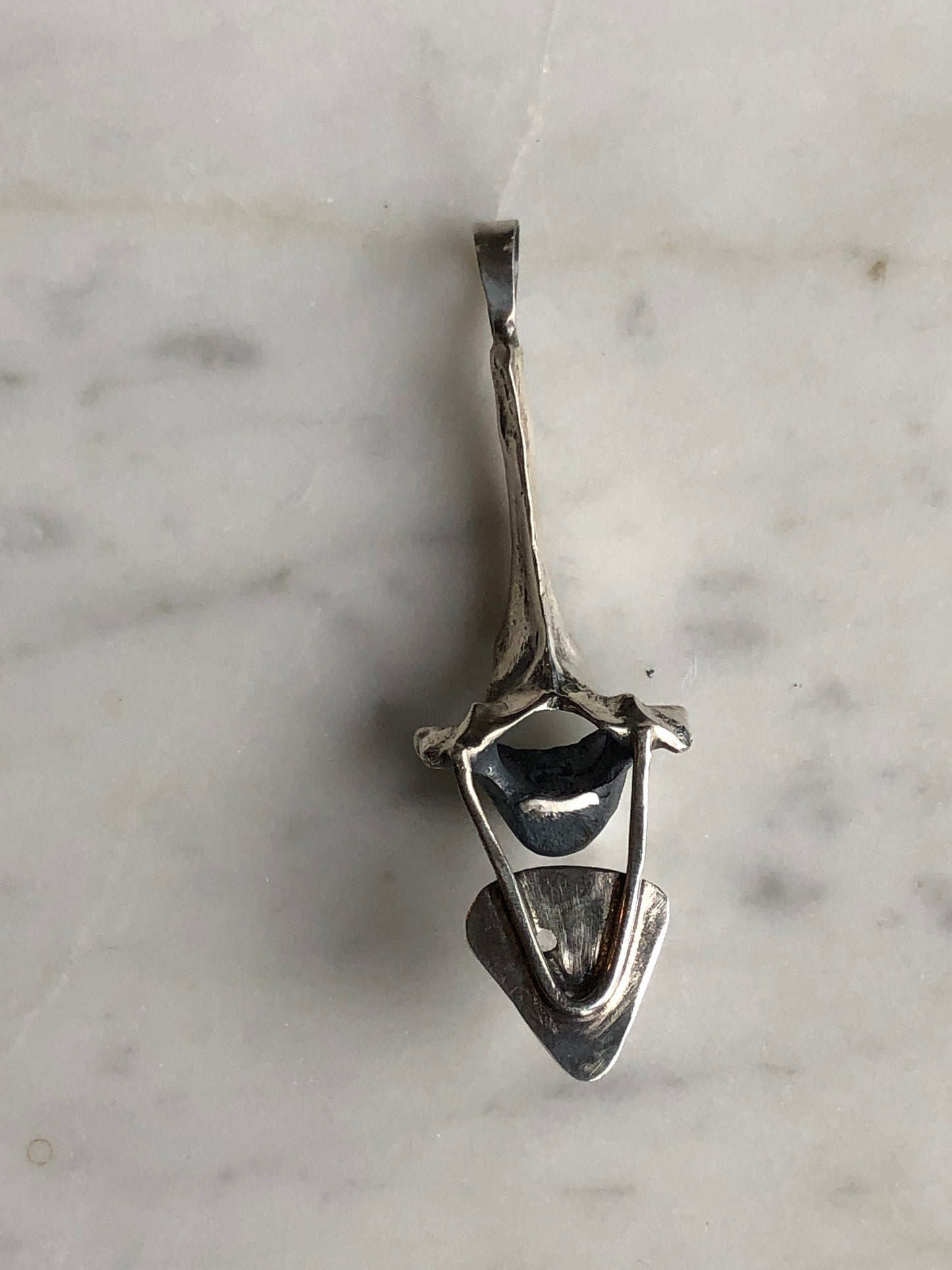 Faceted white topaz with sterling silver fox vertebra pendant